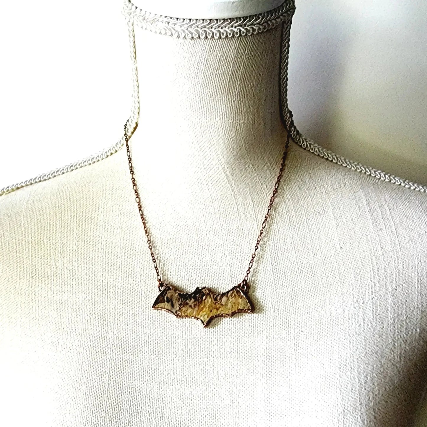 Fossilized Palm Wood Bat Necklace